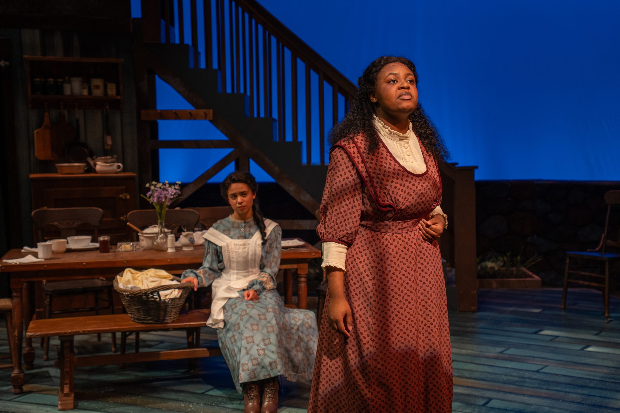Photo from play JOE TURNER'S COME AND GONE of a woman looking out with a woman seated behind.