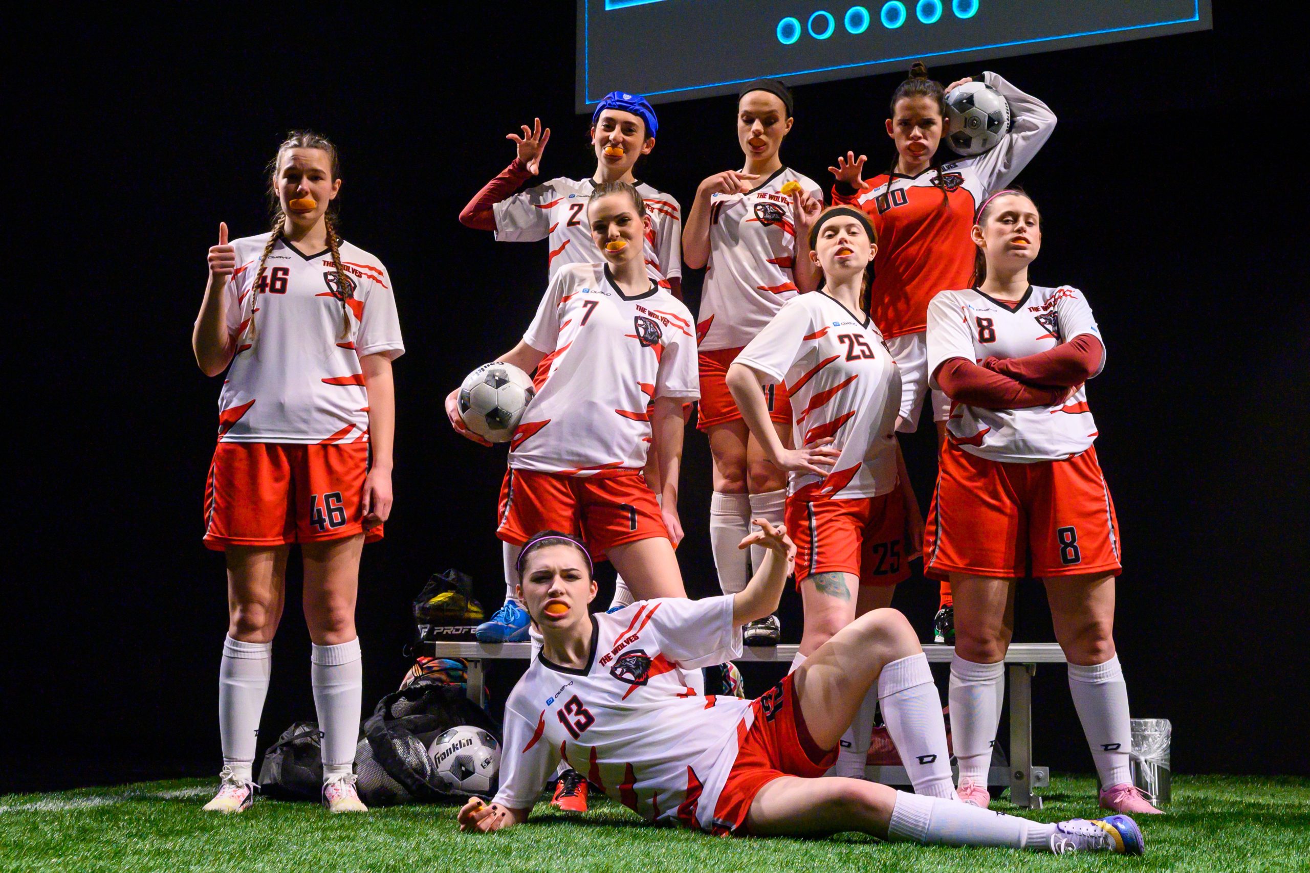 Photo from play THE WOLVES of a girls soccer team mugging for the camera.