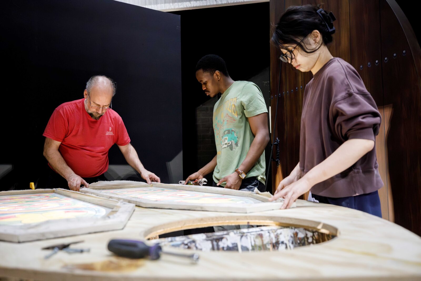 Photo of people working on a piece of scenery.